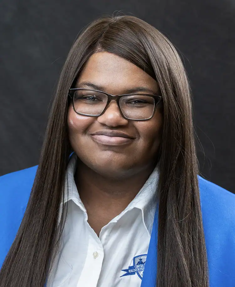 EPI Center logo behind Alicia Smith, professional woman in glasses and blue blazer.