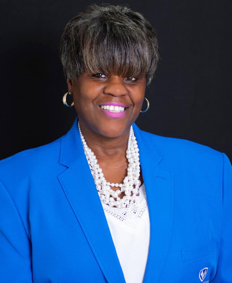 Professional portrait of Michelle Copeland at EPI Center, smiling in a blue blazer.