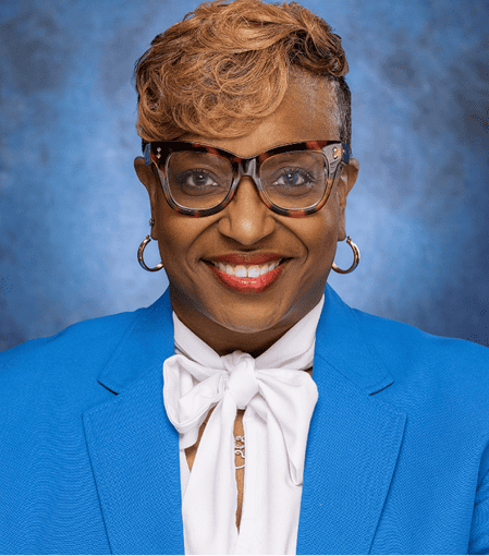 Professional woman in blue blazer smiling, representing EPI Center.